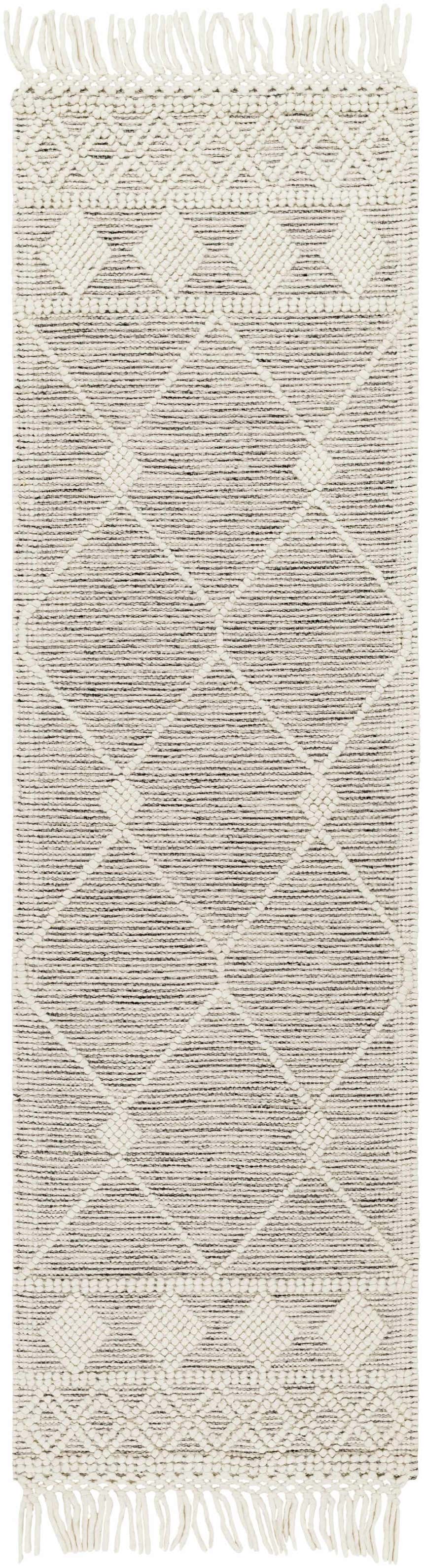 Close-up of the hand woven Hemingway Wool Rug with Tassels. Features a geometric diamond pattern in bone and gray. Design-Runner-2376