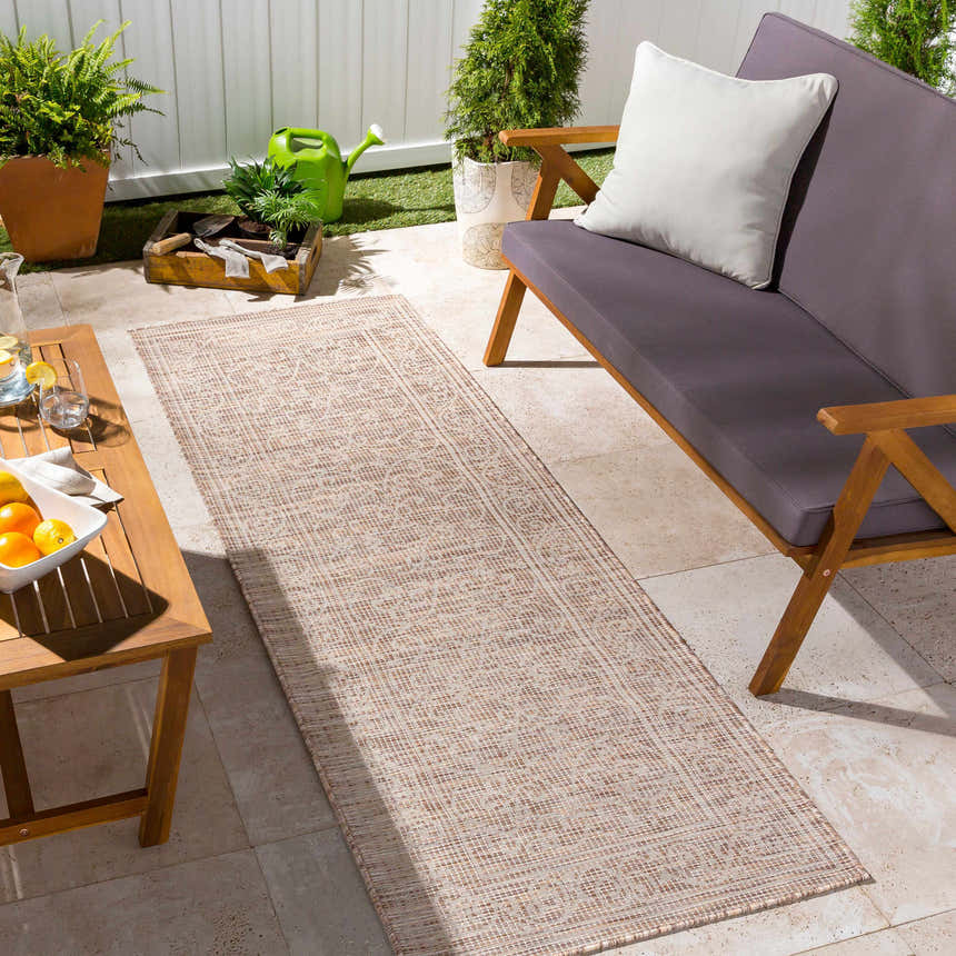 Outdoor patio scene with Coolville Brown Flatweave Area Carpet, wooden furniture, plants, and neutral color palette. Roomscene-Runner