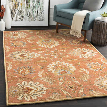Living room scene with the Chesterton Hand Tufted Orange rug, blue chair, and abstract art. Warm, inviting, and stylish. Roomscene-Rectangle