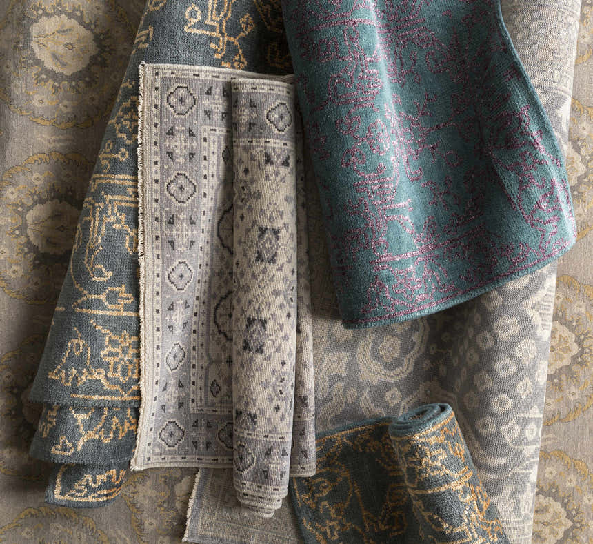 Close-up of rolled Redvale Area Rug in burgundy, teal, and gray. Hand-knotted wool and viscose rug with contemporary design. Styleshot