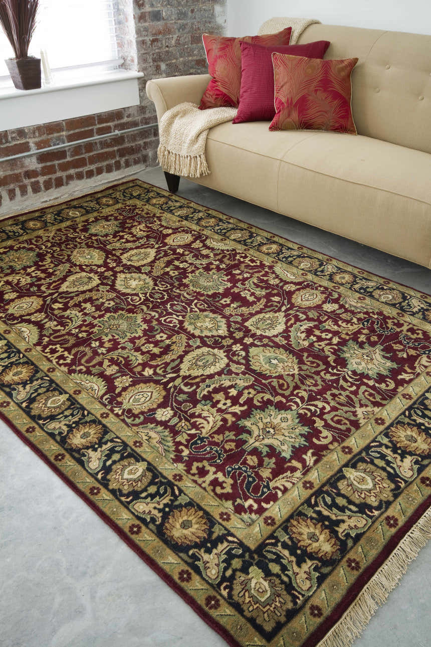 Living room scene with a brick wall and the Coalinga Premium Wool Area Carpet in brick red and brown tones. Roomscene-Rectangle