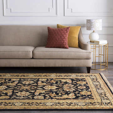 Living room scene with a Black&Gold Premium Wool Rug, beige sofa, and gold accent table. Roomscene-Rectangle