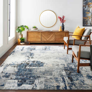 Living room scene with Campsall Area Rug in cream, dark gray, and light blue. Mid-century modern decor with wood accents. Roomscene-Rectangle