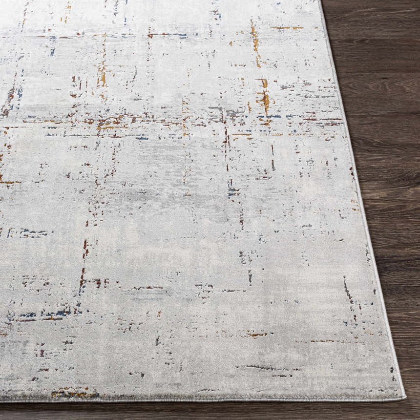Close-up of Concordia Faux Silk Rug showing its off-white base with burgundy, orange, and navy abstract pattern. Front