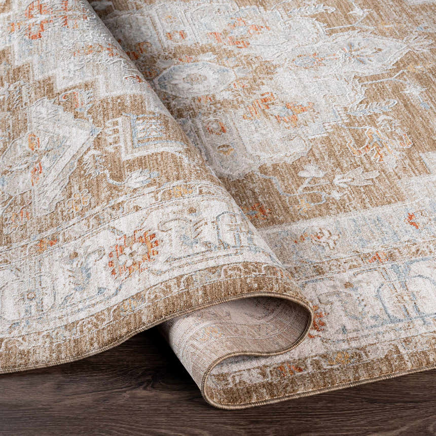 Close-up of a rolled Canadensis Thick Luxe Traditional Turkish Rug showing brick red, beige, and blue details. Fold