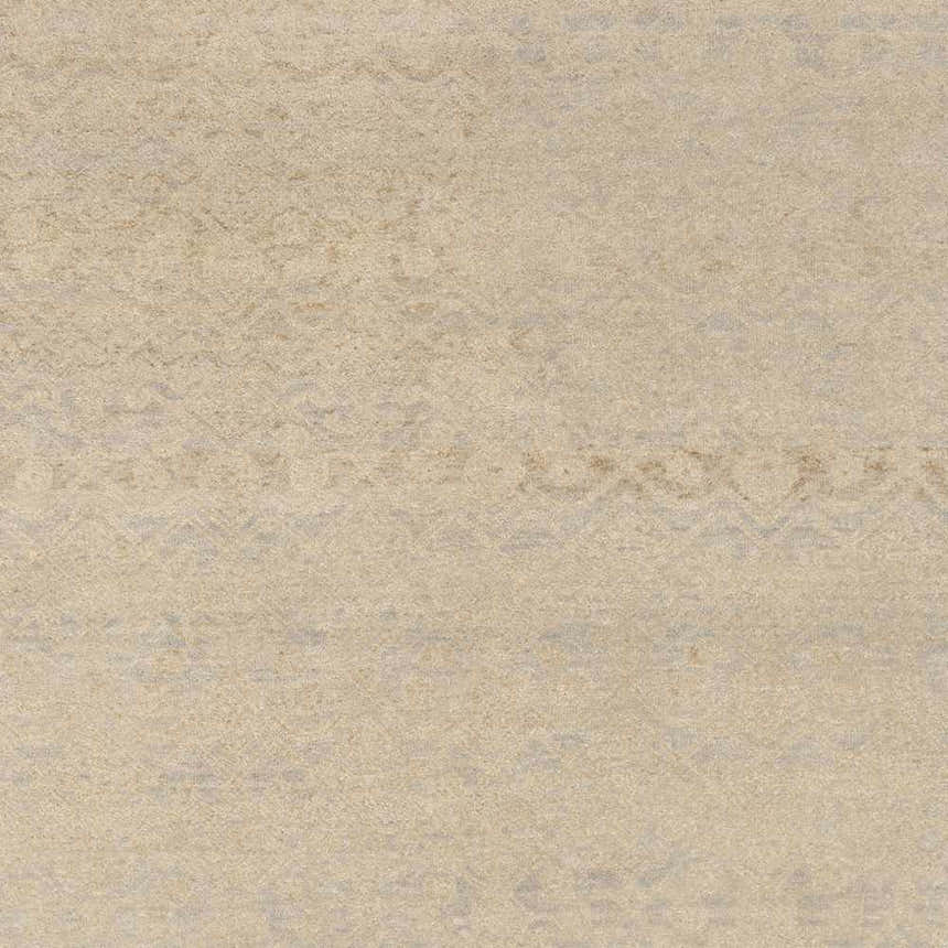 Close-up of the Colwich Area Carpet. Light beige wool rug with a subtle, pale blue geometric pattern. Hand-knotted texture. Swatch