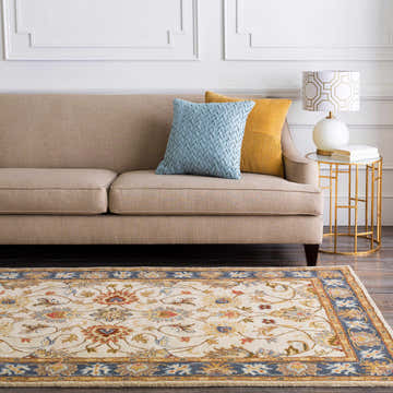 Living room scene with a beige sofa, gold accents, and the Cherryfield 1125 Yellow&Sage Wool Rug with a traditional floral pattern. Roomscene-Rectangle