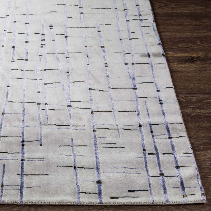 Close-up of Copake Wool&Viscose Rug. Gray rug with black and charcoal lines on dark wood floor. Contemporary style. Front