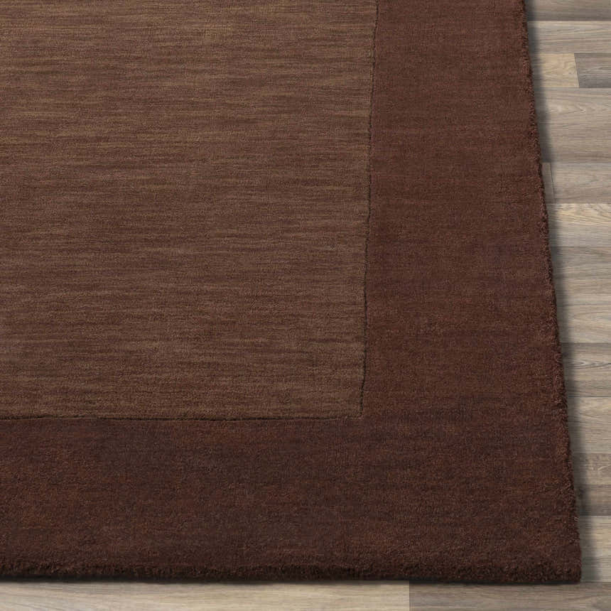 Close-up of a Bordered Solid Brown Wool Rug showing the texture and color variations. Front