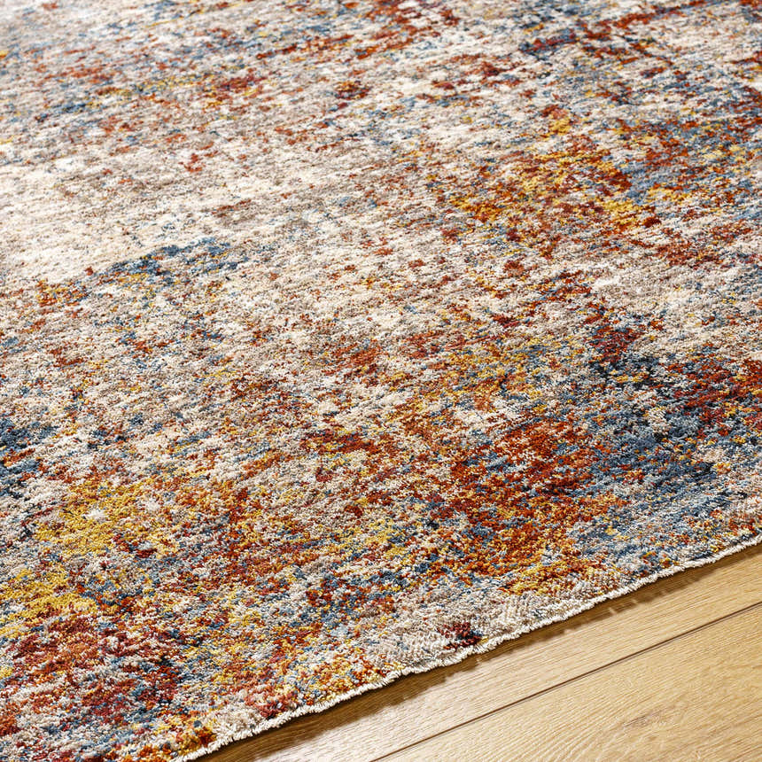 Close-up of the Cranfield Area Rug showing a textured, contemporary pattern in brick red, cream, blue, and mustard. Texture