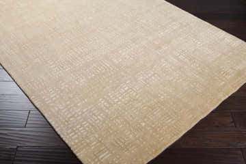 Close-up of the beige Crossnore Area Carpet showing its subtle geometric pattern and hand-knotted texture. Corner