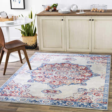 Farmhouse kitchen with Carron Area Rug in blue and red, under a round table and cream-colored cabinets. Roomscene-Rectangle