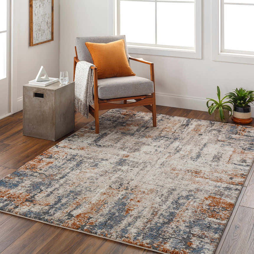 Living room scene with a Cashi Thick Luxe Rug in clay, dark brown, mocha, and off white. Mid-century chair and concrete side table. Roomscene-Rectangle