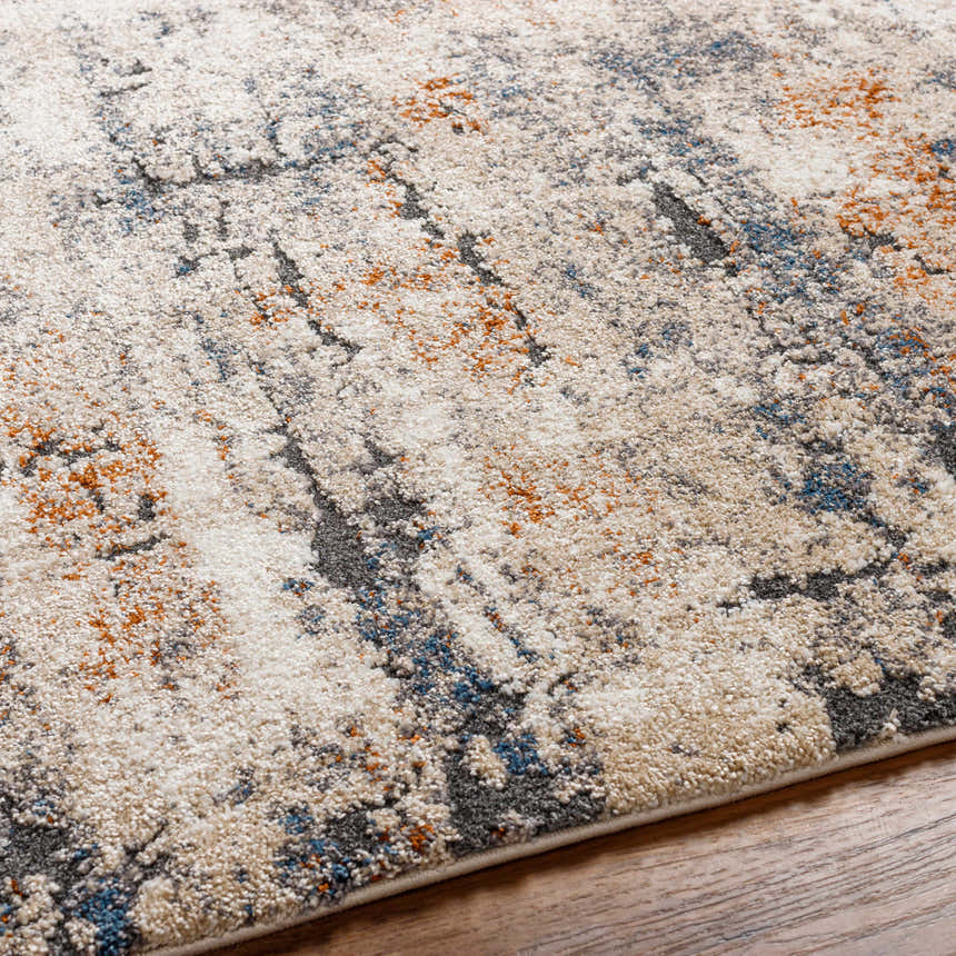 Close-up of the Cashi Thick Luxe Rug showing its plush texture and abstract pattern in clay, off-white, blue, and dark brown. Texture