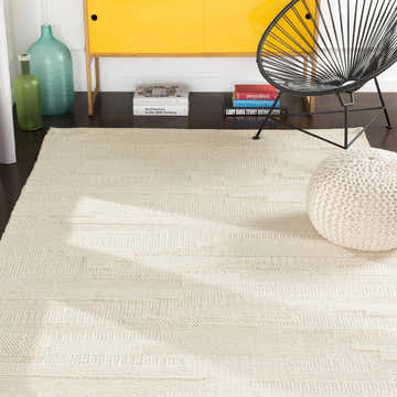 Contemporary kitchen scene with a cream Cypress Textured Wool Rug, yellow cabinet, black chair, and knitted pouf. Roomscene-Rectangle