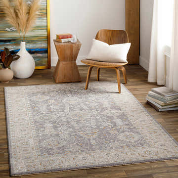 Living room scene with a gray, beige, and brown Dalupirip Thick Luxe Statement Rug, wood chair, and modern decor. Roomscene-Rectangle