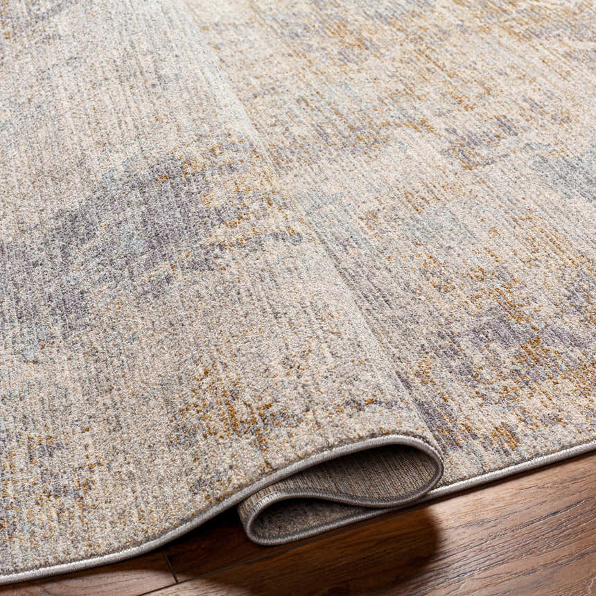 Close-up of the Deka Deep Teal Thick Luxe Rug showing its brown, gray, and teal contemporary pattern and plush texture. Fold