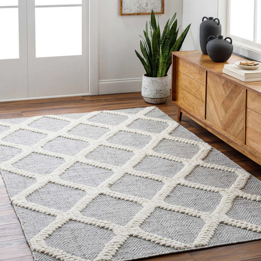 Entryway with Della Area Rug in dark gray, gray, and light gray. Geometric, hand-woven design. Wood floors and cabinet. Roomscene-Rectangle