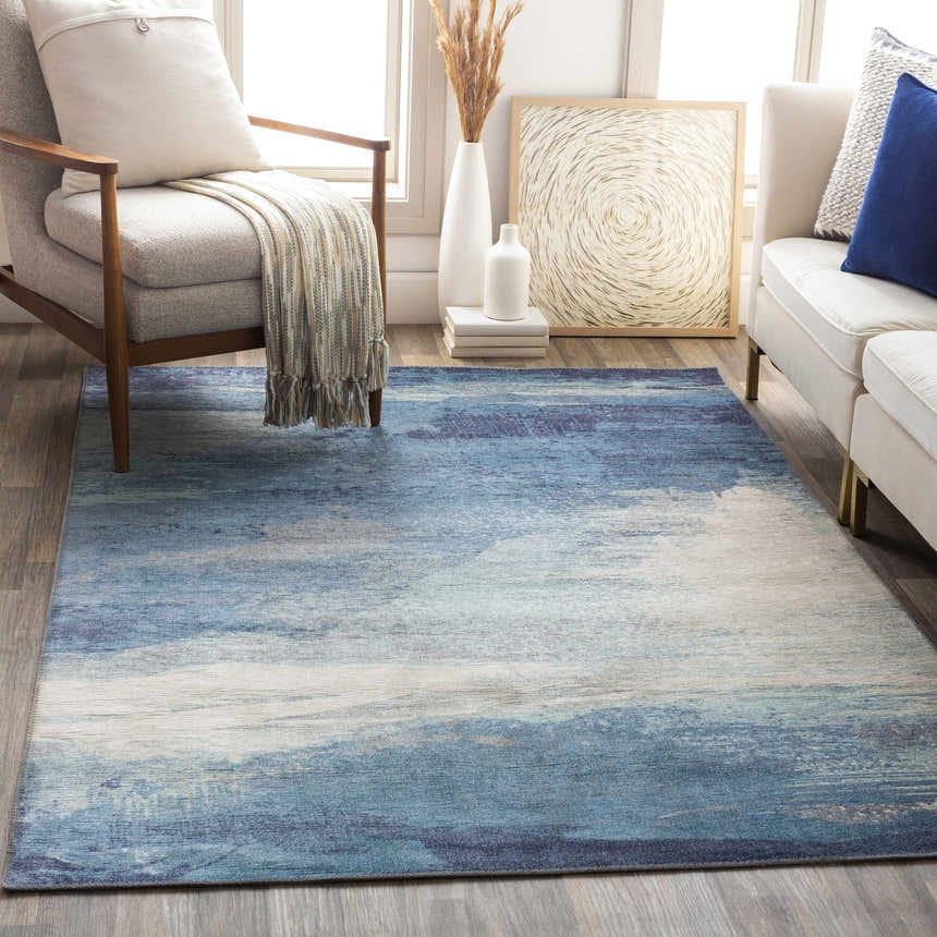 Living room scene with blue, cream, and charcoal Deport Area Rug. Coastal Grandmother style. Roomscene-Rectangle