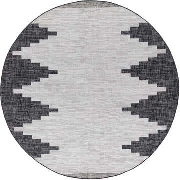 Close-up of a round Djugun Outdoor Rug. Black and off-white Southwestern-inspired geometric pattern. Machine woven polypropylene. Design-Round-710