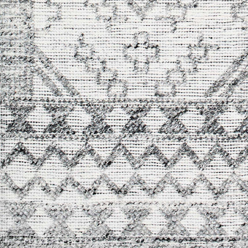 Close-up of the hand-woven Adan Area Rug featuring a gray and white geometric pattern and textured recycled PET yarn. Swatch