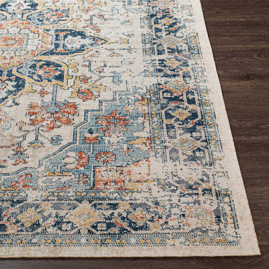 Close-up of the Dorval Traditional Rug. Cream rug with brick red, denim, and navy blue oriental pattern on dark wood floor. Front