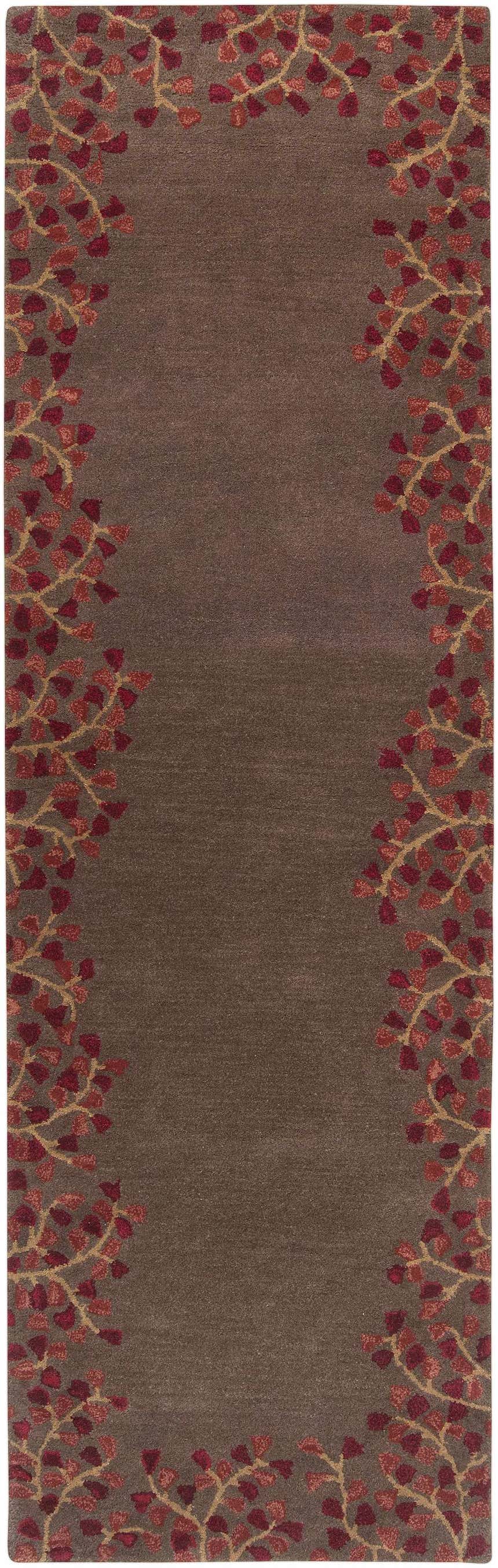Close-up of the wool Dovercourt Clearance Rug. Features a brown center with brick red and mustard leaf pattern border. Design-Runner-268