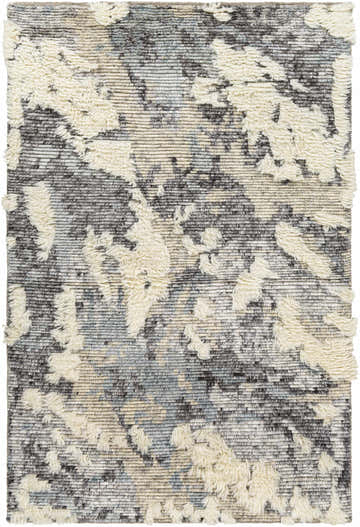 Close-up of the Doveton Plush Wool Rug. Features a cream shag design on a gray, black, and blue hand-knotted wool base. Design-Rectangle-576