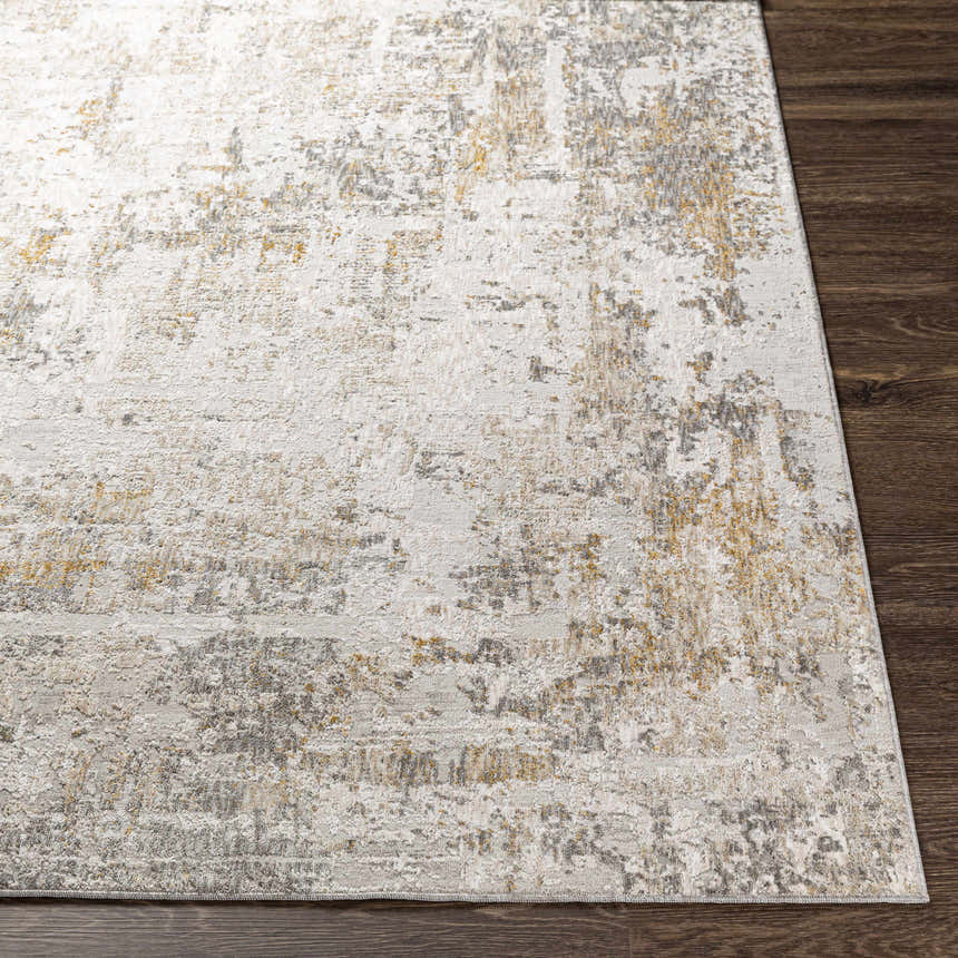 Close-up of the textured Dowell Luxe Area Rug. Features off-white, gray, and mustard hues with a distressed, contemporary design. Front