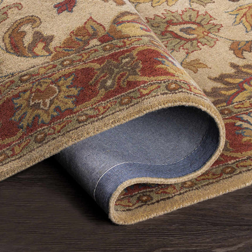 Close-up of the hand-tufted Cherryfield Brown & Rust 1001 Wool Rug showing its traditional floral pattern and wool texture. Fold