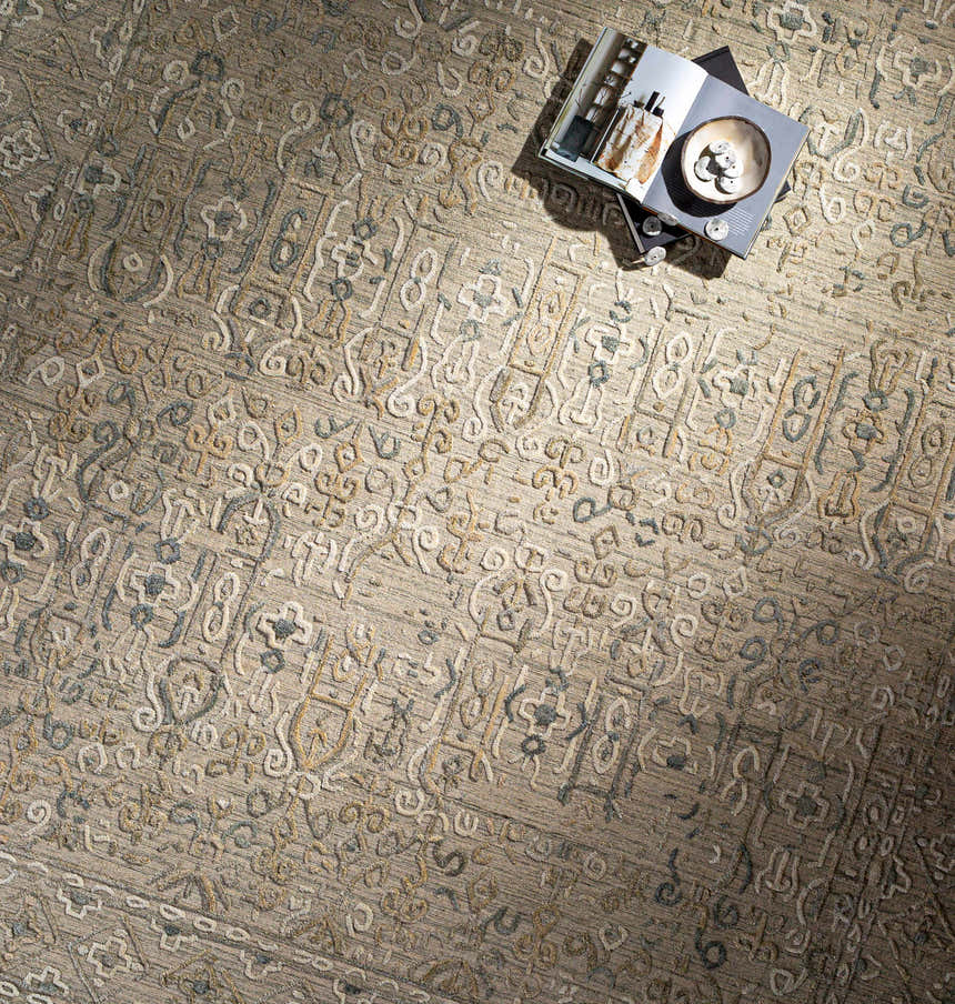 Close-up of the Dubbo Area Rug showing beige, charcoal, and oatmeal hues with a subtle, hand-loomed bohemian pattern. Styleshot
