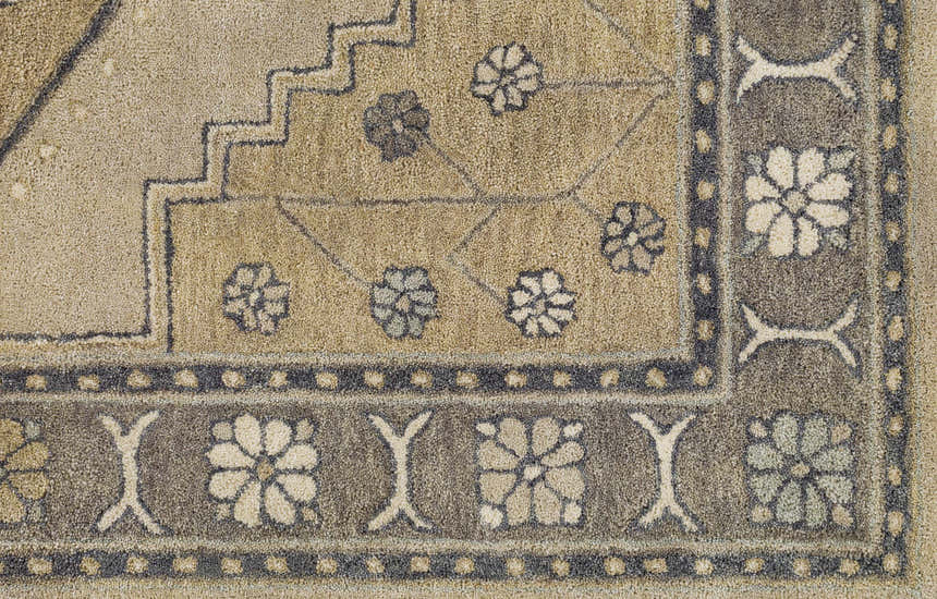 Close-up of the hand-tufted Duckenfield Area Rug, a wool rug with a traditional floral and geometric design in tan and gray. Swatch