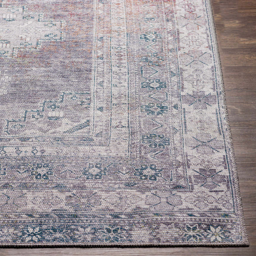 Close-up of the Baltinglass Gray Washable Rug showing its traditional oriental pattern, gray, cream, and brown colors, and woven texture. Front