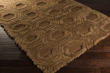 Close-up of the brown Edmonds Area Rug. Hand-woven wool rug with a geometric shag design and soft texture. Corner