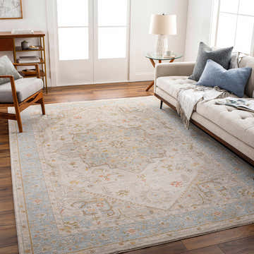 Living room with a beige sofa and the Ehan Cream Thick Luxe Oushak Rug with blue, amber, and pink accents. Roomscene-Rectangle