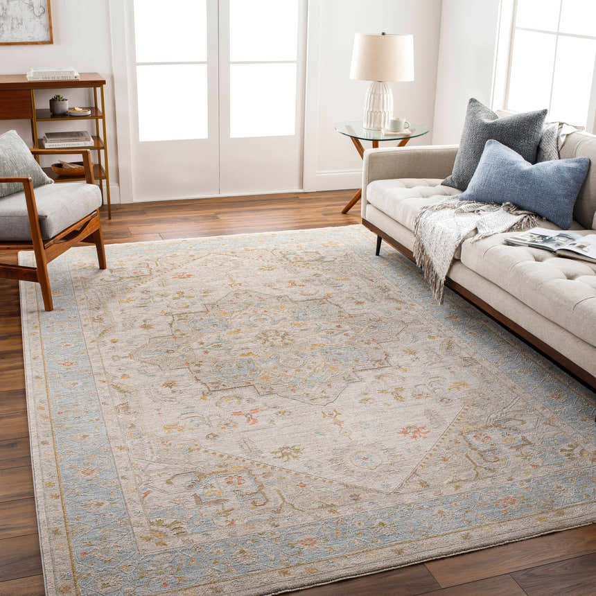 Living room with a beige sofa and the Ehan Cream Thick Luxe Oushak Rug with blue, amber, and pink accents. Roomscene-Rectangle