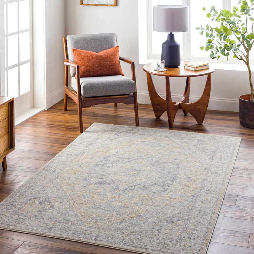 Living room scene with the Ehan Cream Thick Luxe Oushak Rug, gray chair, wood accents, and natural light. Farmhouse style. Roomscene-Rectangle