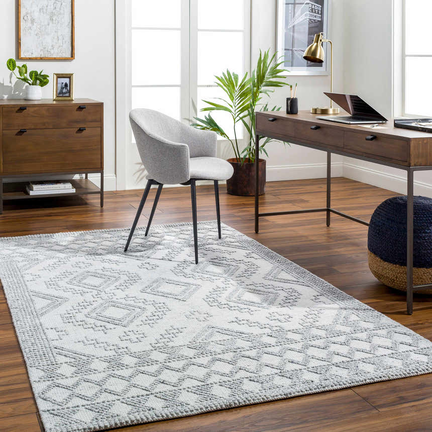 Home office with Elin Area Rug in arctic stone and gray, wood desk, gray chair, and natural light. Roomscene-Rectangle