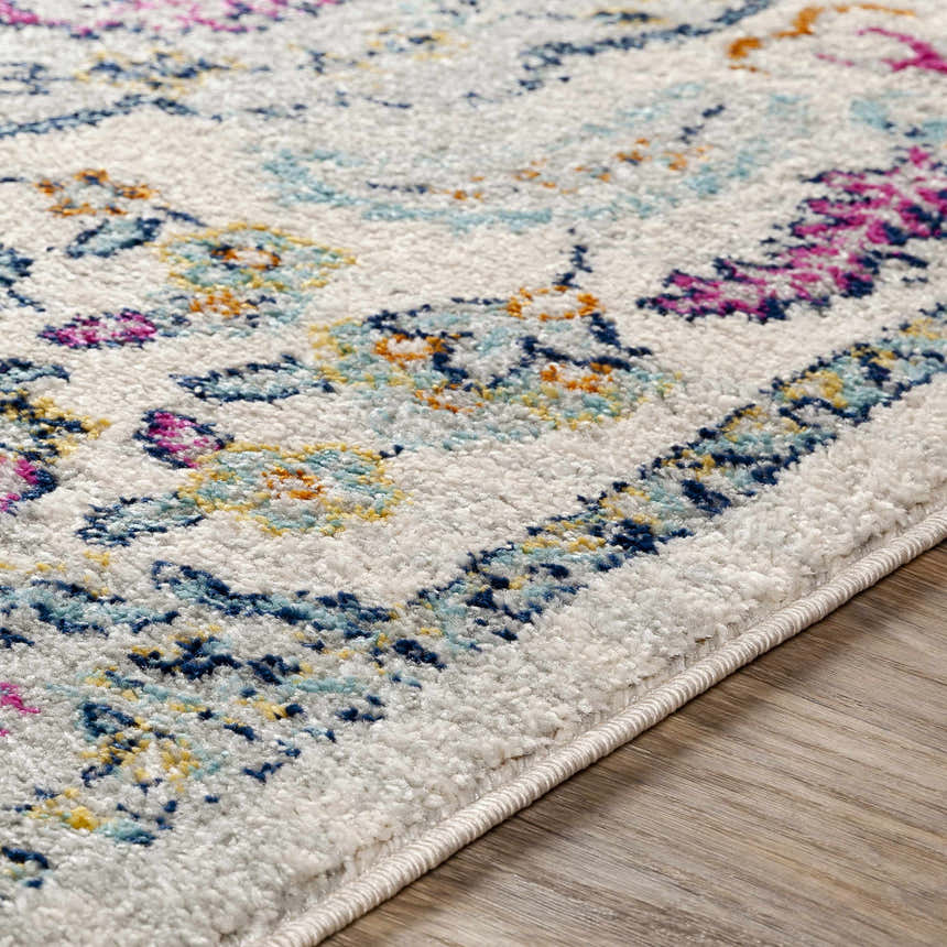 Close-up of the Errol Area Rug showing its white base with aqua, burnt orange, and pink floral pattern. Texture