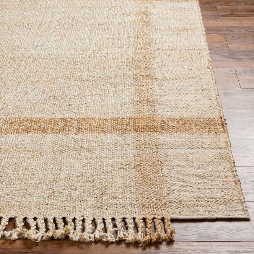Close-up of Errin Jute Area Rug showing beige, camel, and natural jute tones with a geometric pattern and braided fringe. Front