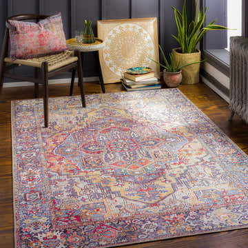Cozy room scene with the Neyland Iris Area Rug, chair, side table, plants, and vintage decor. Roomscene-Rectangle