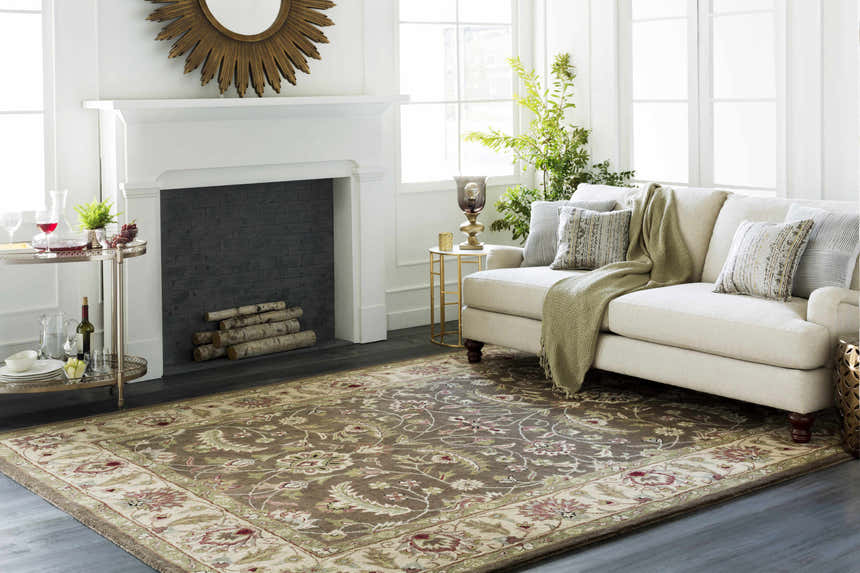 Living room scene with a floral Eupora Wool Rug, beige sofa, fireplace, and gold accents. Roomscene-Rectangle