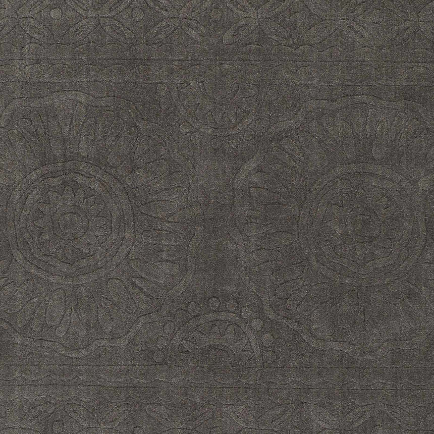 Close-up of the charcoal Eversholt Clearance Rug, a hand-loomed wool rug with a subtle, contemporary floral pattern. Swatch