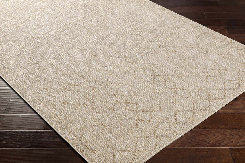 Close-up of the Maunawili Cream Nordic Rug showing its woven texture and geometric pattern on dark wood flooring. Corner