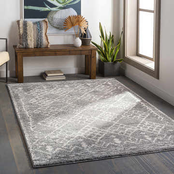 Entryway with gray Fadden Area Rug, wood bench, and potted plant creating a welcoming, transitional style. Roomscene-Rectangle