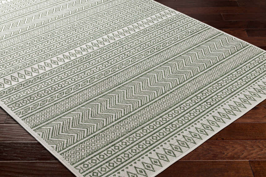 Close-up of Madras Natural Gray Green All Over Performance Area Rug featuring geometric patterns and farmhouse style. Corner