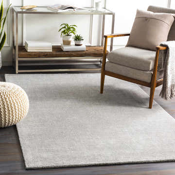 Living room scene with a gray Fife Area Rug, wood chair, and neutral decor. Roomscene-Rectangle