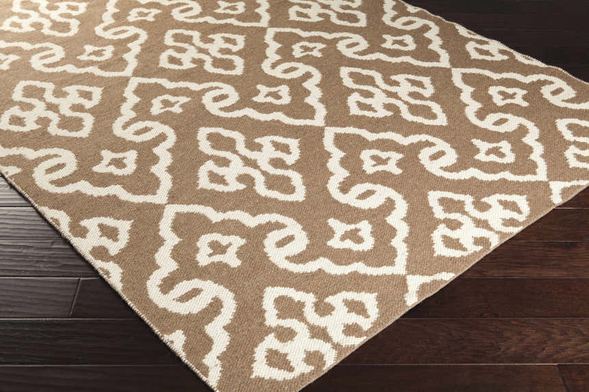 Close up of Fitzpatrick Reversible Area Carpet showing cream and medium brown bohemian pattern and hand woven texture. Corner