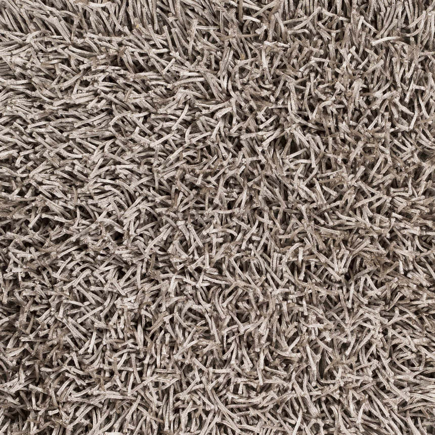 Close-up of the Browder Solid Brown Shag Rug, showing its dense, hand-woven texture and contemporary style. Texture