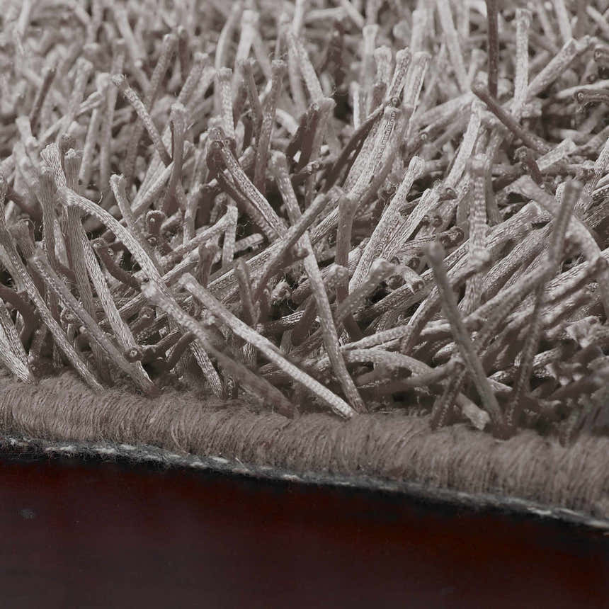Close-up of the Browder Solid Brown Shag Rug showing its soft, textured pile and hand woven construction. Clearance item. Pile